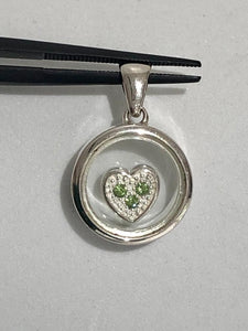 silver pendant with a floating heart