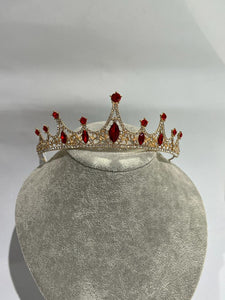 tiara with red rhinestones and in gold colour metal